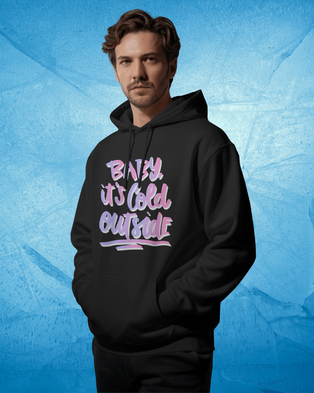 Man wearing a black hoodie with colorful text on a blue textured background