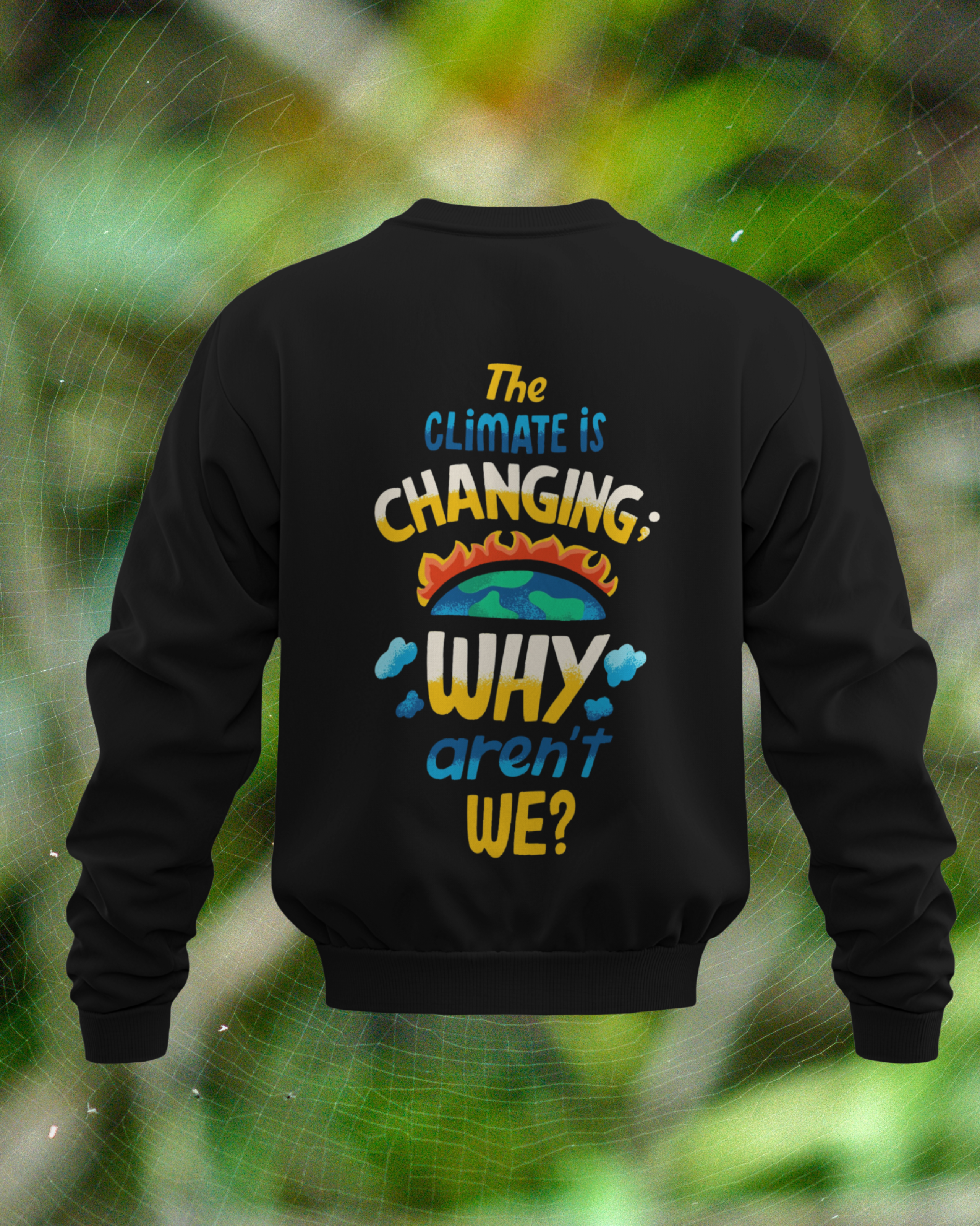 Black sweatshirt with climate change message on a blurred green background