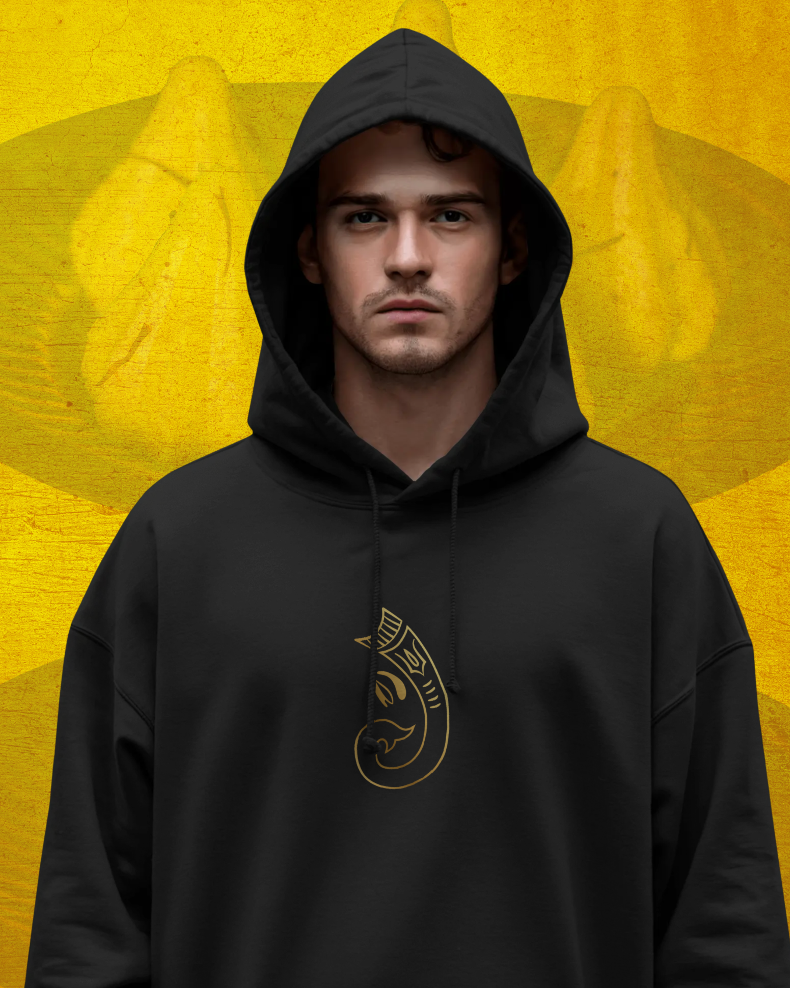 Person wearing a black hoodie with a logo on a yellow background
