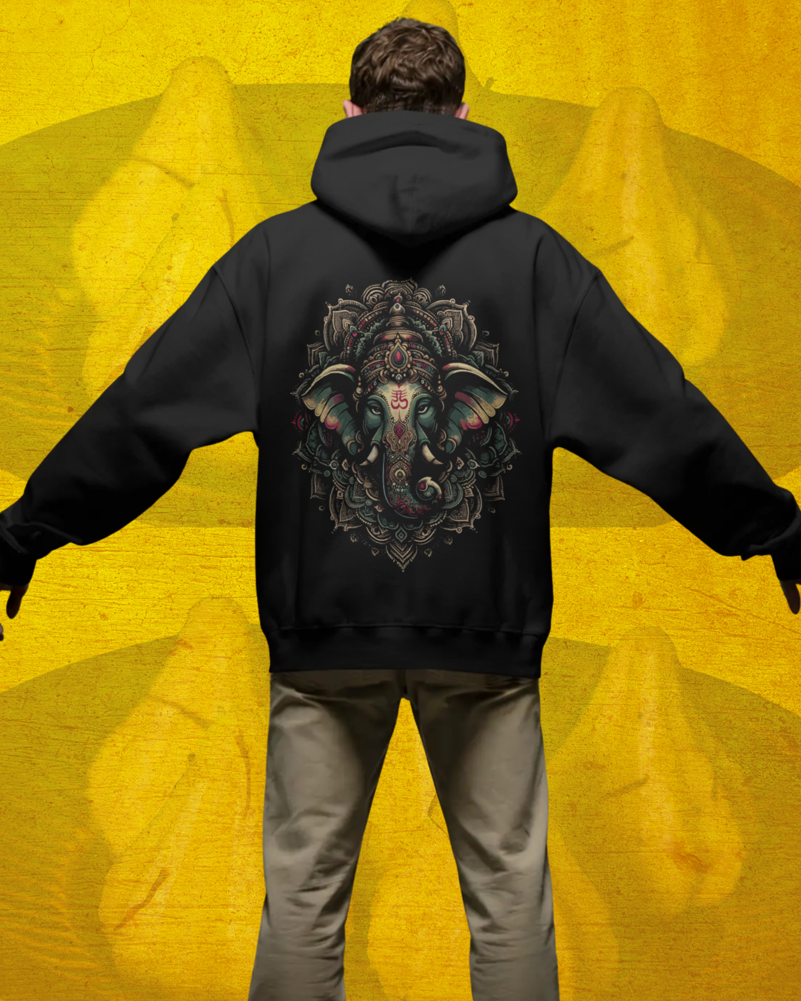 Person wearing a black hoodie with a colorful design on the back against a yellow background