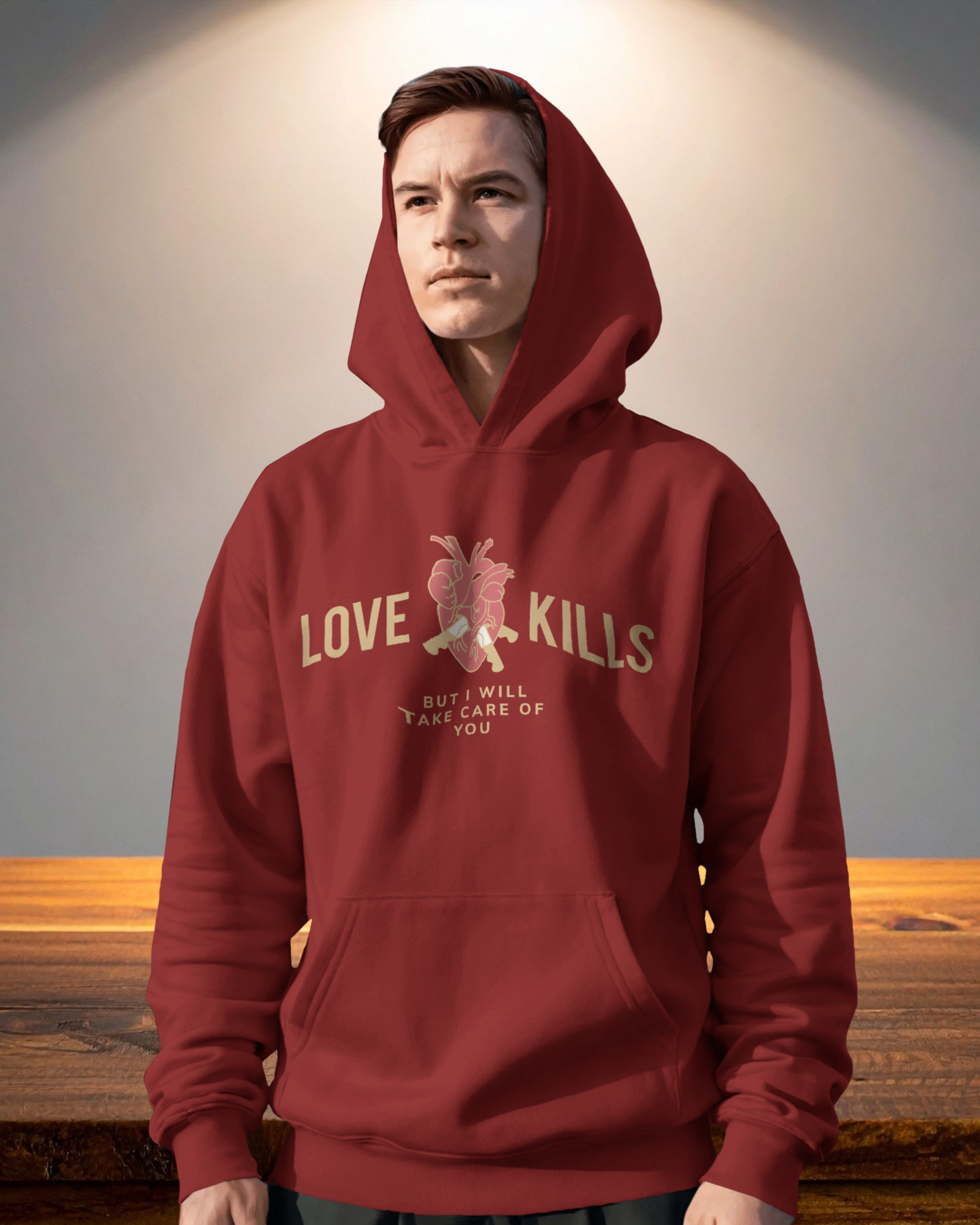 Person wearing a red hoodie with text and graphic design on a wooden surface