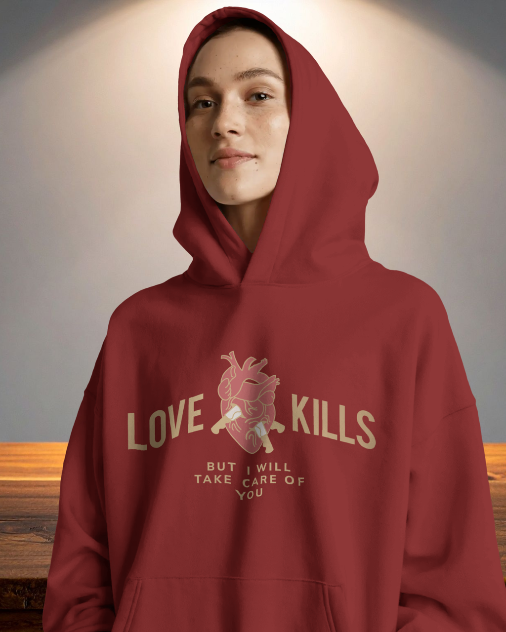 Person wearing a red hoodie with a graphic design and text