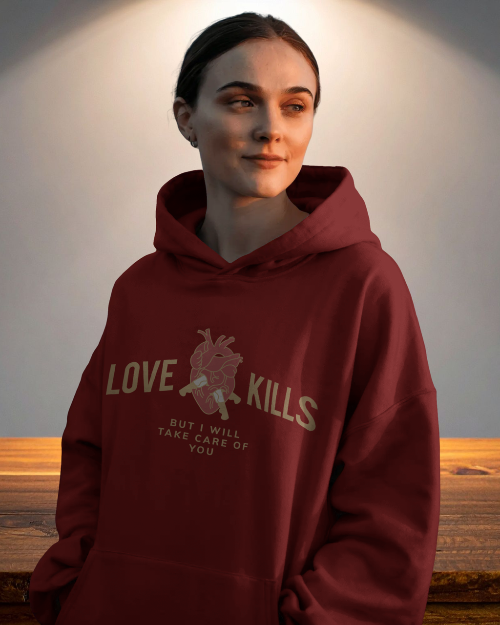 Person wearing a maroon hoodie with text and graphic design