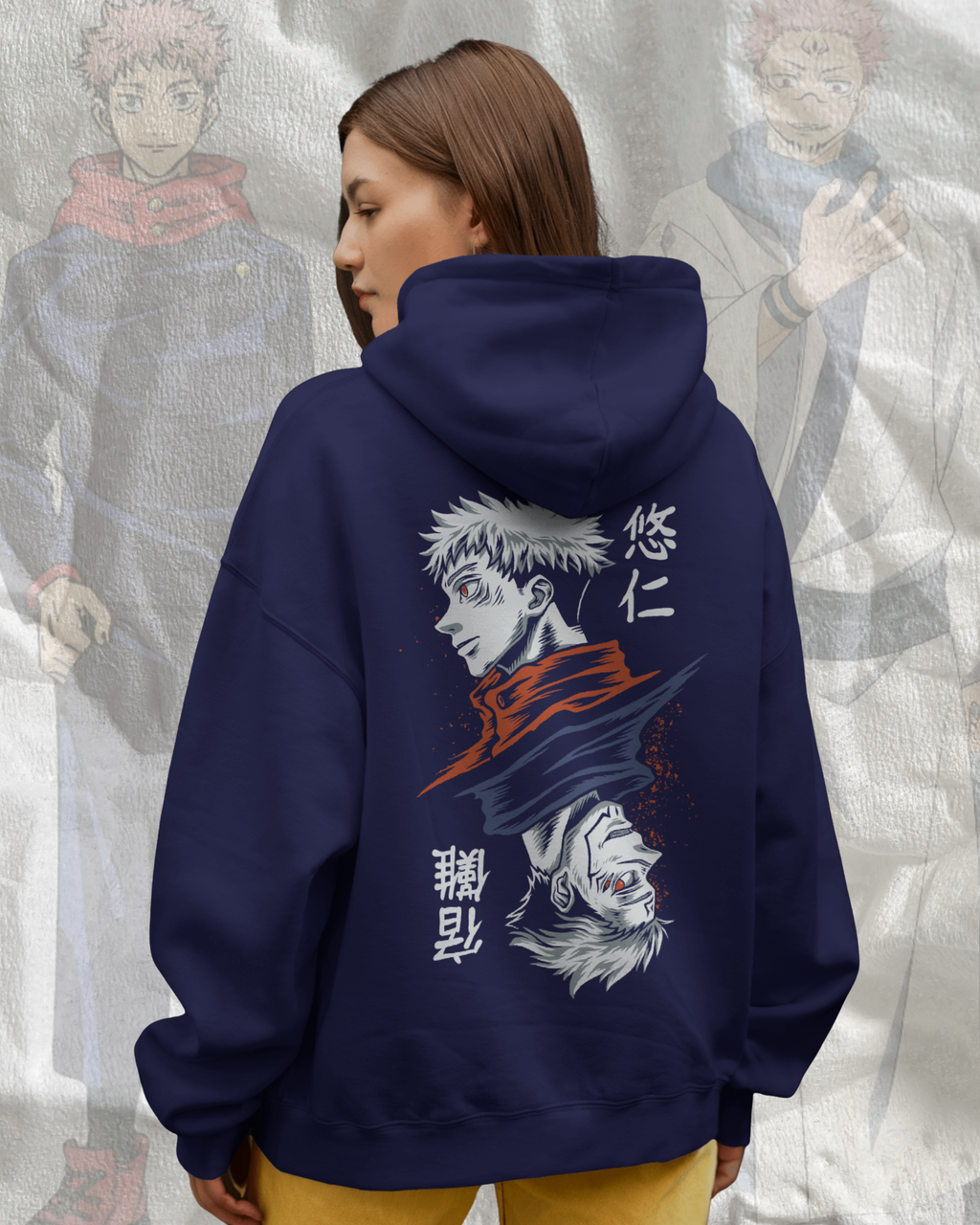 Person wearing a navy hoodie with anime character design and text, standing against a light gray textured background